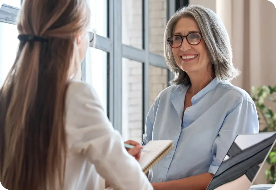A woman checks into the front desk
