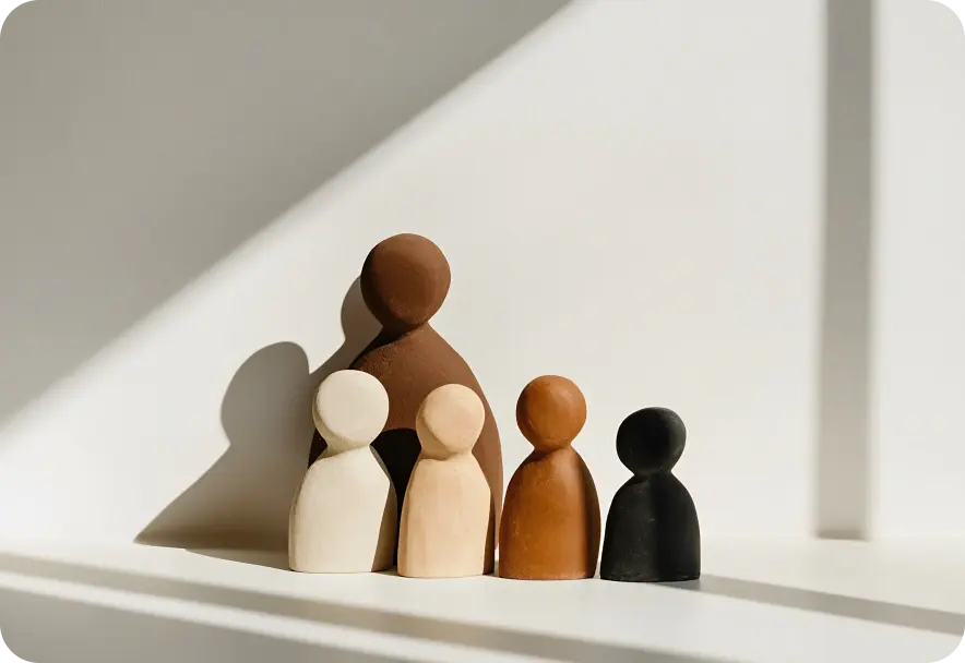 Five clay abstract sculptures resembling the human form in various sizes and shades.